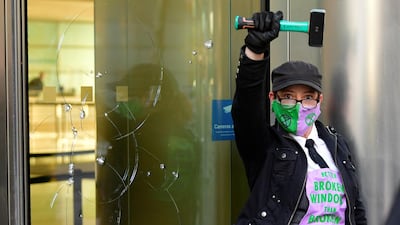 An activist raises her hammer during the protest. Reuters