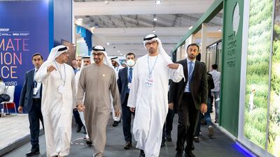 Sheikh Mohamed, second left, tours the conference. Rashed Al Mansoori / UAE Presidential Court