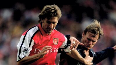United's Teddy Sheringham battles for the ball with Arsenal captain Tony Adams in 2000. Getty