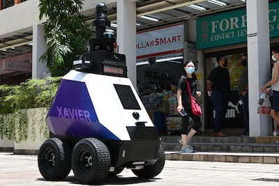 Singapore is trialling patrol robots that blast warnings at people engaging in unsafe behaviour, such as not following social distancing measures. Photo by Roslan Rahman /AFP