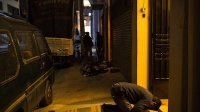 A muslim resident prays outside a mosque in Athens on February 18, 2017. Angelos Tzortzinis / AFP
