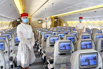 Emirates crew wear personal protective equipment (PPE) on flights during the coronavirus pandemic. Courtesy Emirates