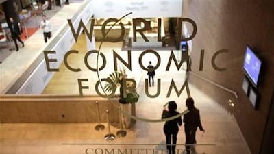 People walk in the main lobby at the World Economic Forum in Davos, Switzerland. The forum will examine whether there is optimism about the global economy in the coming months and, perhaps more importantly, if the levels of trust in business and government are on the rebound. (AP Photo/Virginia Mayo)