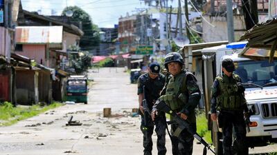 Policemen guard a road in Marawi as government forces continue their assault on June 22, 2017 against militants who seized large parts of the sothern Philippine town in late May. Romeo Ranoco / Reuters