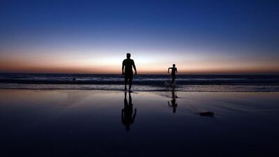 Youngsters enjoy the final moments of a sunset in Mumbai. Divyakant Solanki / EPA