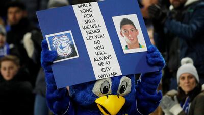 Cardiff City mascot Bartley Bluebird displays a banner paying tribute to Emiliano Sala. Reuters