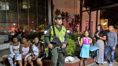 A police officer stands guard after patientswere evacuated from the Colombia Clinic in Cali, Colombia. The quake also rattled northern Peru and parts of Colombia. Luis Robayo / AFP Photo