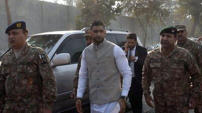 Amir Khan is taken to the memorial at the tragedy-struck army-run school in Peshawar, Pakistan on Monday. A Majeed / AFP