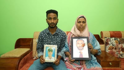 Ainul Hoque's brother Mainul and mother, Lutfa Ara, hold photos of him and await his return to Bangladesh. Photo: The Hoque family
