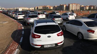 Cars backed up around the Discovery Gardens area in the morning from overnight downpour and waterlogged streets. Pawan Singh / The National