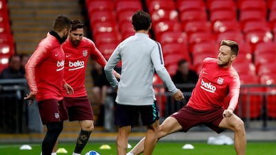 Ivan Rakitic, right, and Lionel Messi take part in a training session at Wembley Stadium ahead of Barcelona's Uefa Chgampions League clash with Tottenham Hotspur. Getty Images