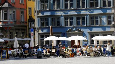 Guests enjoy the sunny weather as they sit in front of a restaurant in Zurich, Switzerland. Reuters