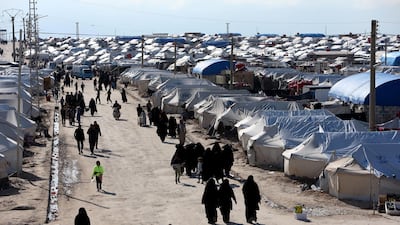 Women walk through Al Hol camp in Syria, which holds about 65,000 displaced people. Reuters