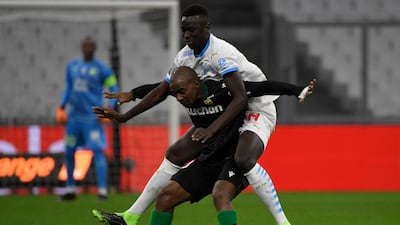 Lens midfielder Gael Kakuta under pressure from Pape Gueye of Marseille. AFP