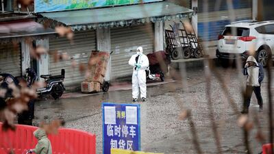 A worker in a protective suit is seen at the closed seafood market in Wuhan, the city in China's Hubei province where the novel coronavirus was first detected, on January 10, 2020. Reuters
