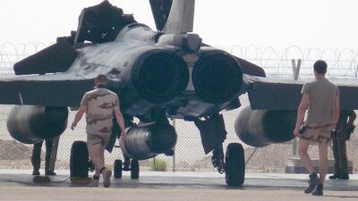 French military support staff walk towards a Rafale fighter jet during a visit by French defence minister Jean-Yves Le Drian to Al Dhafra base, about 32 kilometres south of Abu Dhabi on September 15. AFP Photo