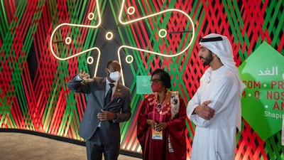 Sheikh Shakhbout listens to a guide at one of the African pavilions.