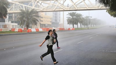 Pedestrians illegally cross Muroor Road despite an overhead bridge. Ravindranath K / The National