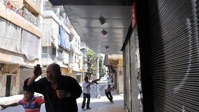 Syrian civilians run for their lives as battling forces approach. Bulent Kilic / AFP Photo