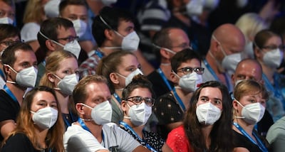 People wear face masks as German pop singer Tim Bendzko performs on stage at the Arena in Leipzig, eastern Germany on August 22, 2020. AFP