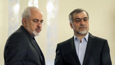 Iranian foreign minister Javad Zarif (L) stands alongside Hossein Fereidoun, president Hassan Rouhani's younger brother and advisor, during a press conference for Mr Rouhani in Tehran on April 3, 2015. Atta Kenare / AFP