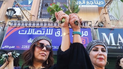 Women hold branches in the centre of the southern Syrian city of Suweida, on August 16, 2022, at the one year anniversary of the protest movement against President Bashar Al Assad, in the mostly Druze province. Photo: Suhail Thubian.