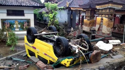A ruined car that was rolled over after the tsunami struck in Anyer. EPA