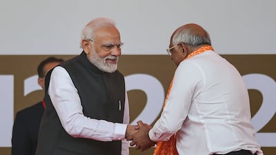 India's Prime Minister Narendra Modi greets Gujarat Chief Minister Bhupendra Patel after the BJP's landslide win in Gujarat state's legislative elections. AFP