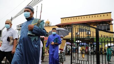 Muslims wearing protective face masks leave a mosque after Eid al-Adha prayers, amid the coronavirus disease (COVID-19) outbreak in Kuala Lumpur, Malaysia July 31, 2020. REUTERS/ Lim Huey Teng