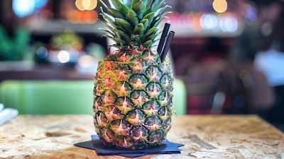 This virgin pina colada is presented in a fresh pineapple and served with a non-plastic straw. Leslie Pableo / The National