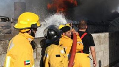 Civil Defence firefighters try to control the fire which broke out in Ajman.