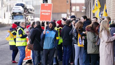 Striking workers gather outside passport office in Glasgow. PA