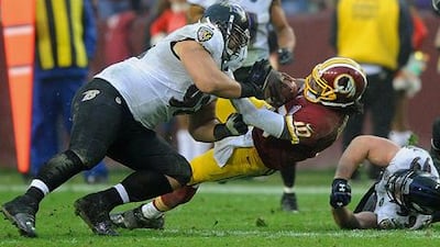 Washington quarterback Robert Griffin III is hit by Baltimore defensive end Haloti Ngata.