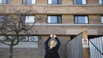 A relative gestures to a resident in a window at a long-term care home, in Toronto. Bloomberg