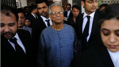 Muhammed Yunus, centre, emerges from the High Court in Dhaka, where he has been fighting the decision to remove him from his post in the Grameen Bank.