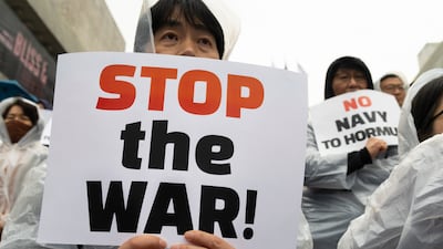 Anti-war protesters in Seoul shout slogans and parade with placards at a rally opposing US President Donald Trump’s request for South Korea to send warships to the Strait of Hormuz. EPA