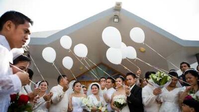 Balloons are released after a mass wedding where 14 Filipino couples were married at St Mary's Catholic Church in Dubai yesterday.