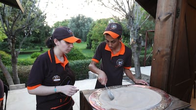 Staff prepare food for guests. EPA