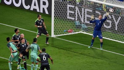 Portugal forward Cristiano Ronaldo (C) scores a goal past Wales goalkeeper Wayne Hennessey (R) during the Euro 2016 semi-final football match between Portugal and Wales at the Parc Olympique Lyonnais stadium in Décines-Charpieu, near Lyon, on July 6, 2016. Jean-Philippe Ksiazek / AFP