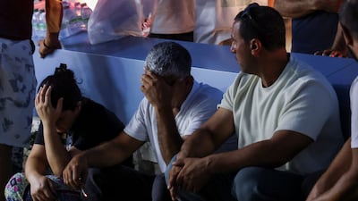 People gathering by a hospital are in shock. Reuters