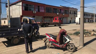 A resident looks at houses with broken windows near the site of an explosion. AFP