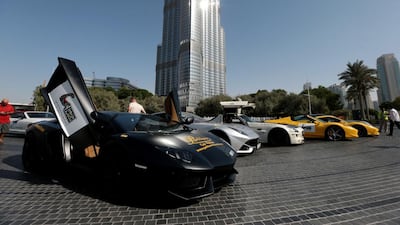 A fleet of super cars at the Burj Khalifa while taking part in a rally from Sky Dive Dubai as part of the upcoming Big Boys Toys show in Dubai on September 30, 2014. Christopher Pike / The National