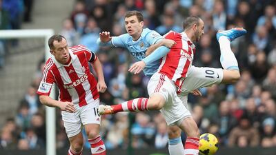 Stoke City defender Marc Wilson, right, tangles with Manchester City striker Edin Dzeko during yesterday’s match at Etihad Stadium. The Manchester club are not in Premier League action next weekend as they face Sunderland in the League Cup final at Wembley Stadium on Sunday. Clive Brunskill / Getty Images