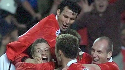 Solskjaer is mobbed by teammates after scoring United's winner. AFP