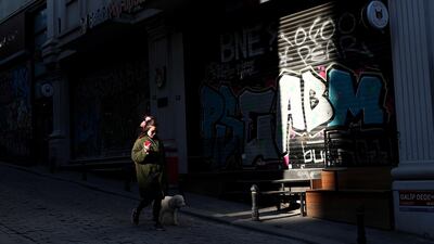 A woman walks with her dog during lockdown in Istanbul, Turkey. EPA
