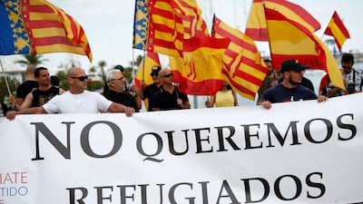 A banner states 'We don't want refugees' at a demonstration called by far-right political party Espana 2000 (E-2000) against the arrival of the 'Aquarius' rescue ship in Valencia. Pau Barrena / AFP