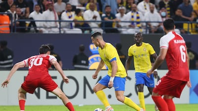 Persepolis' Georgian defender Giorgi Gvelesiani marks Nassr's Portuguese forward Cristiano Ronaldo. AFP