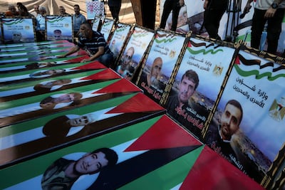 Demonstrators stand next to mock coffins symbolising Palestinian prisoners who died in Israeli jails, during a protest in front of the office of the International Committee of the Red Cross in Gaza. AP