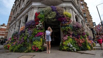 LONDON, ENGLAND - MAY 21: A woman stands outside a large floral display at a clothing shop during the Chelsea in Bloom floral art show on May 21, 2018 in London, England. This year is the 13th Chelsea in Bloom and the theme is 'Summer of Love', inspired by the Royal Wedding and the 1960's/70's cultural revolution. The floral show is also a competition that is entered by various Chelsea retailers, restaurants and hotels with entries being judged by an expert panel. (Photo by Chris J Ratcliffe/Getty Images)