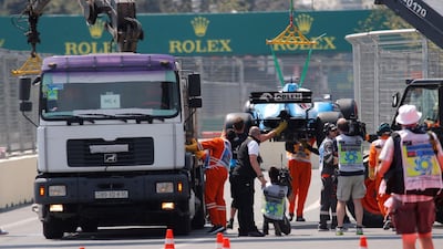 George Russell's damaged Williams is recovered after stopping on track after hitting a loose manhole cover in Azerbaijan. Reuters